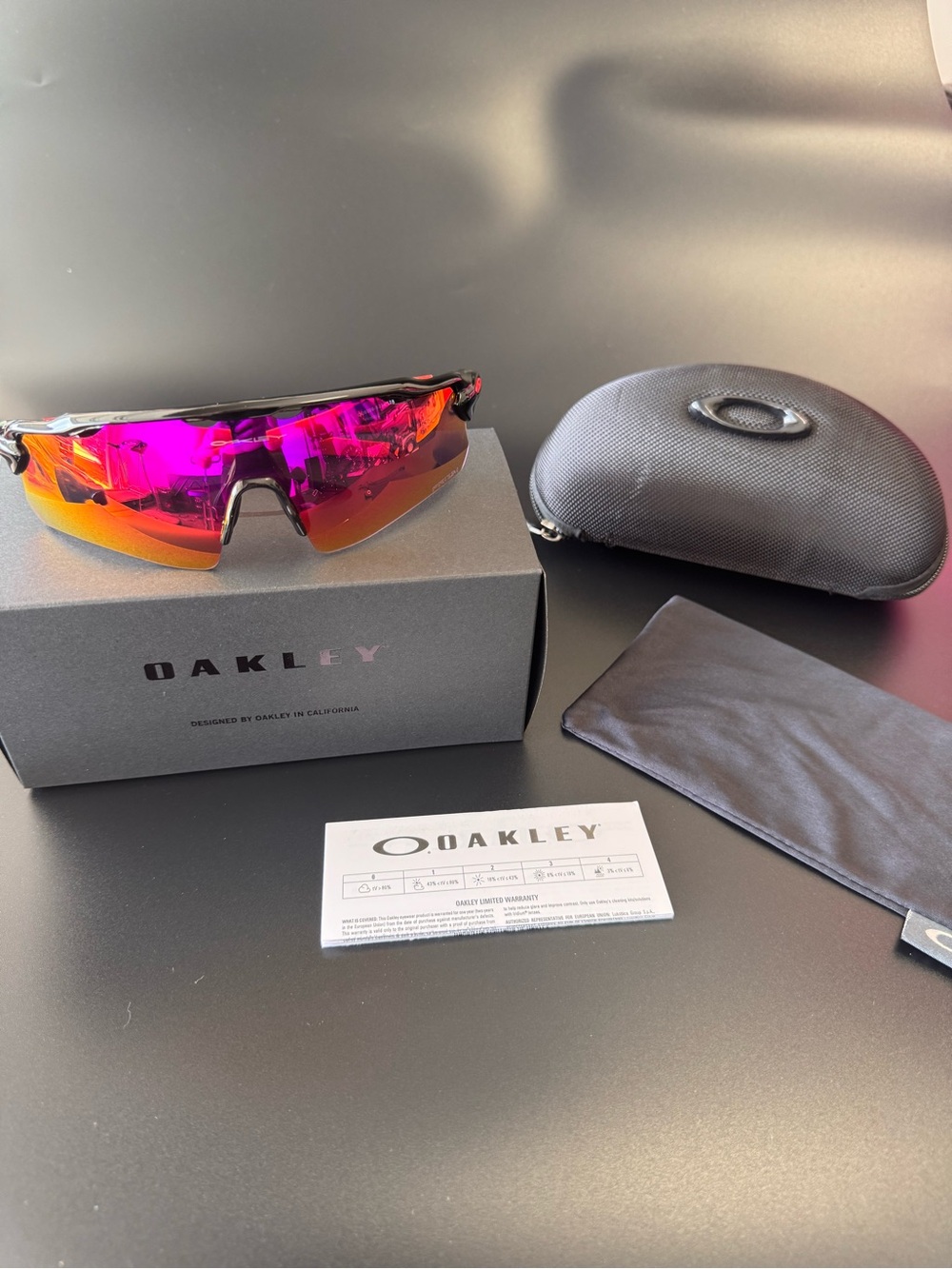 Oakley Sunglasses with Black Frame and Red Temples, Orange-Red Mirrored Lens
